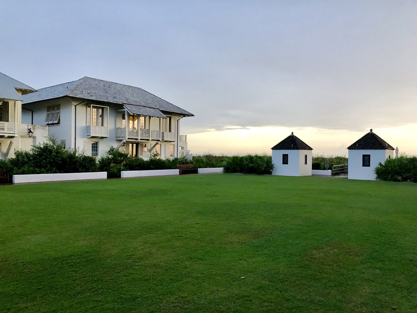 Eastern Green lawn, small access buildings and adjacent residential architecture in Rosemary Beach.