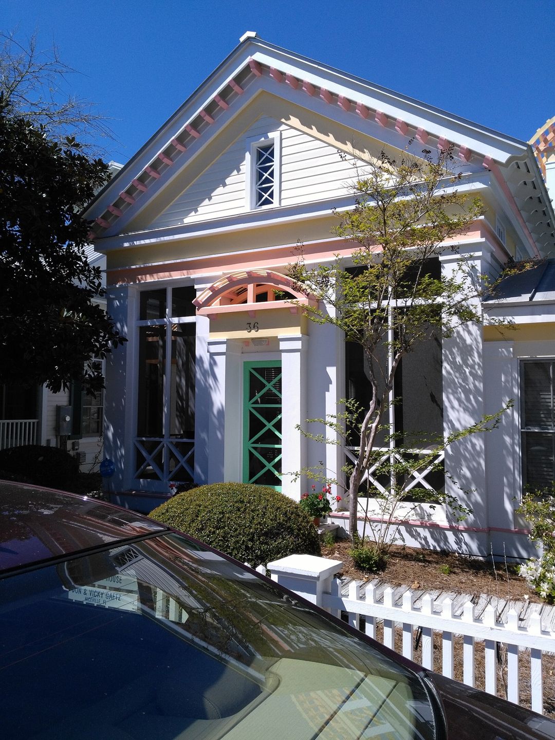 Street-side photograph of the house identified by the photographer as the house used in The Truman Show; a parked car is visible in the foreground.